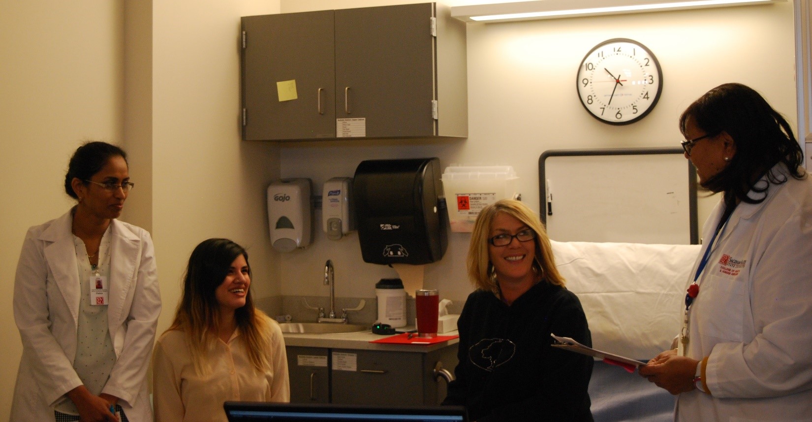 Behavioral health simulation with two students, standardized patient and faculty